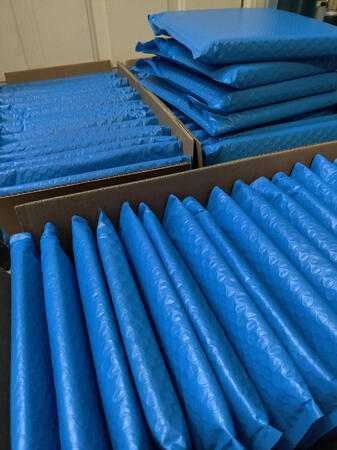 Photo of cardboard boxes filled with completed packages awaiting pickup. Photo of cardboard boxes filled with completed packages awaiting pickup.